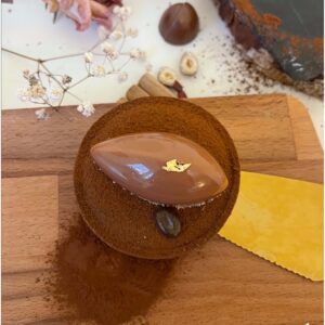 Tartelette chocolat café noisette sur une pelle à gâteau vue de dessus