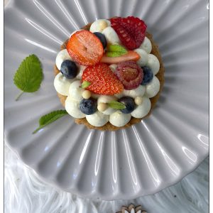 Tartelette fruits rouges, mélisse et vanille vue du dessus sur une assiette
