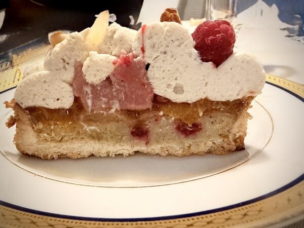 Part de tarte Melba montrant la chantilly, le crémeux et le biscuit